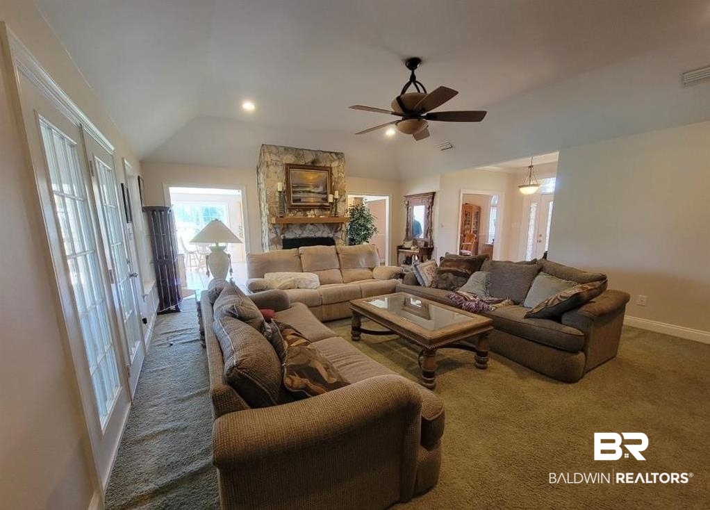 16311 Old Brady Road Bay Minette, AL 36507 - Photo 5 of 38 Living area featuring a vaulted ceiling with a ceiling fan, recessed lighting, and a stone-clad fireplace