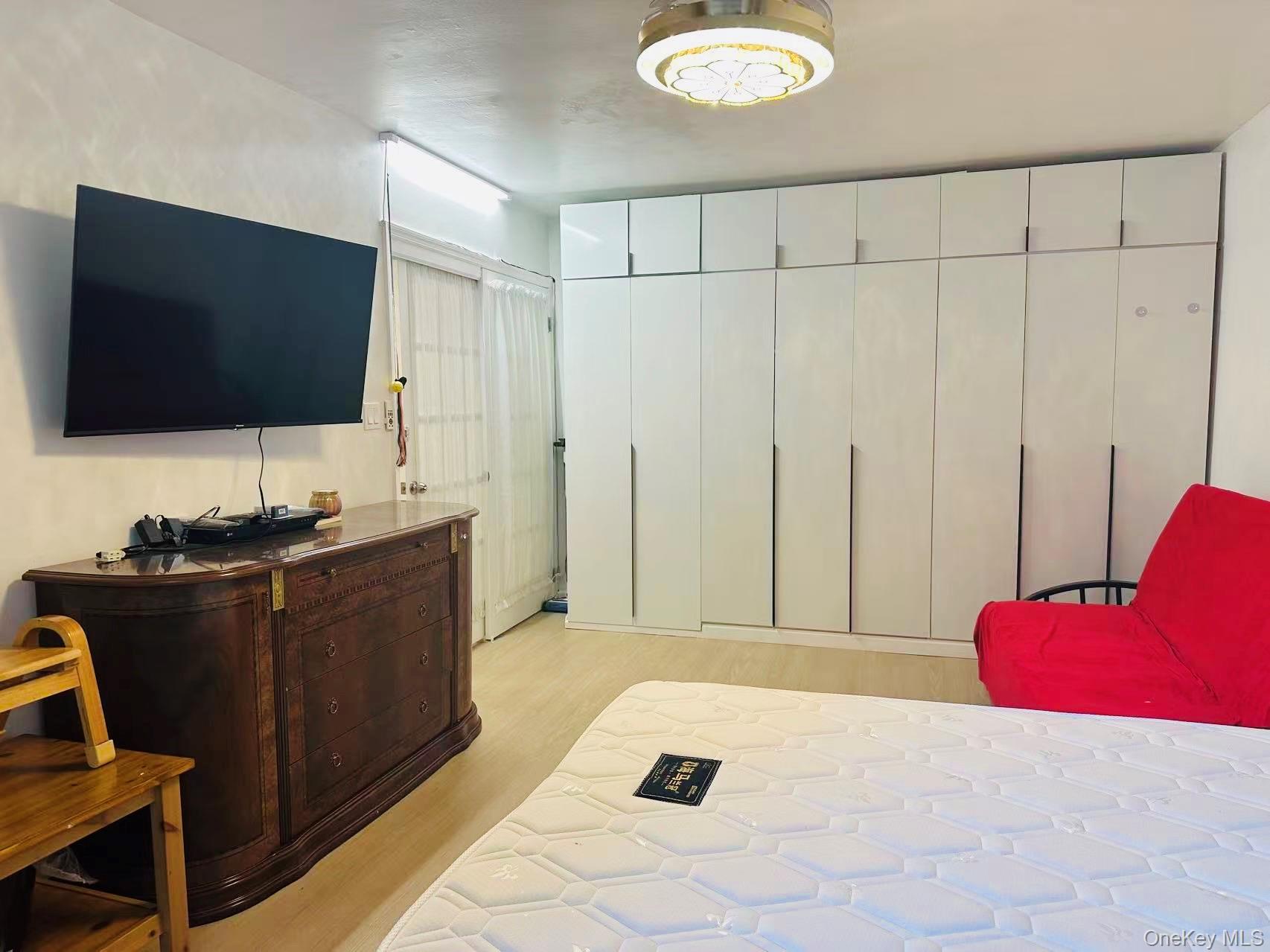 64-74 Saunders Street, Unit 2D Queens, NY 11374 - Photo 5 of 10 a bed room with a bed and a television