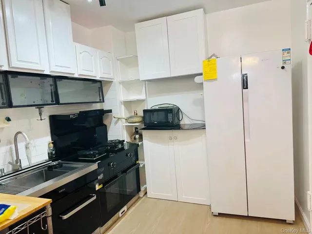 a kitchen with a sink and a stove top oven