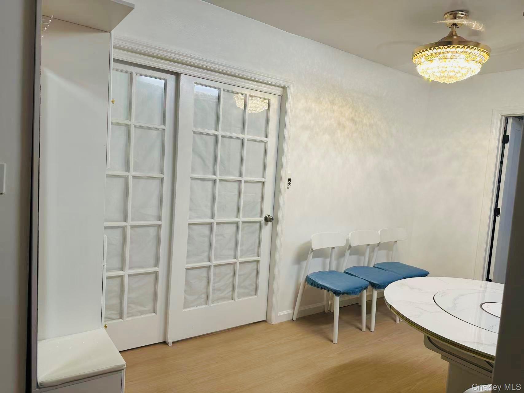 64-74 Saunders Street, Unit 2D Queens, NY 11374 - Photo 8 of 10 a view of a room with furniture and wooden floor