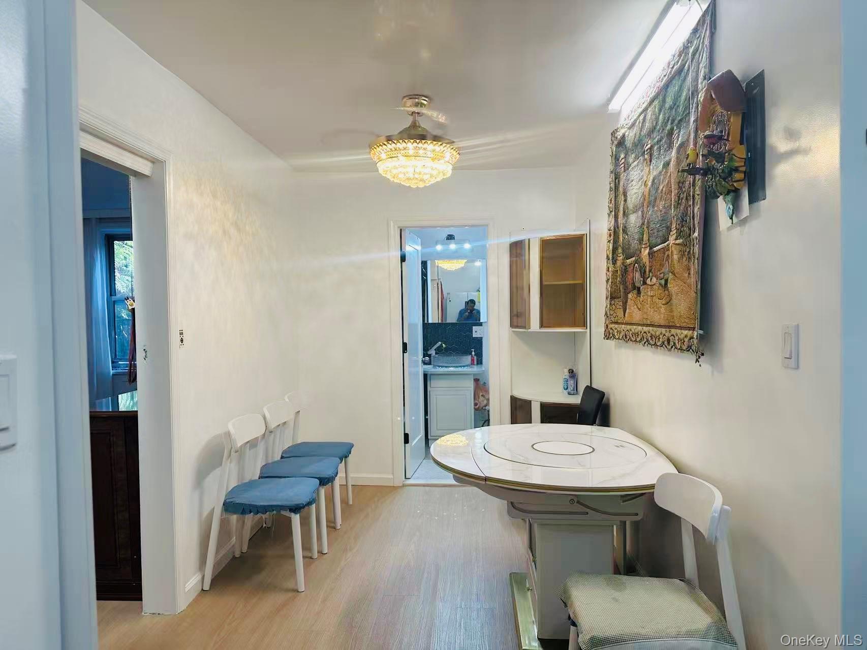 64-74 Saunders Street, Unit 2D Queens, NY 11374 - Photo 9 of 10 a bathroom with a sink a toilet and a mirror