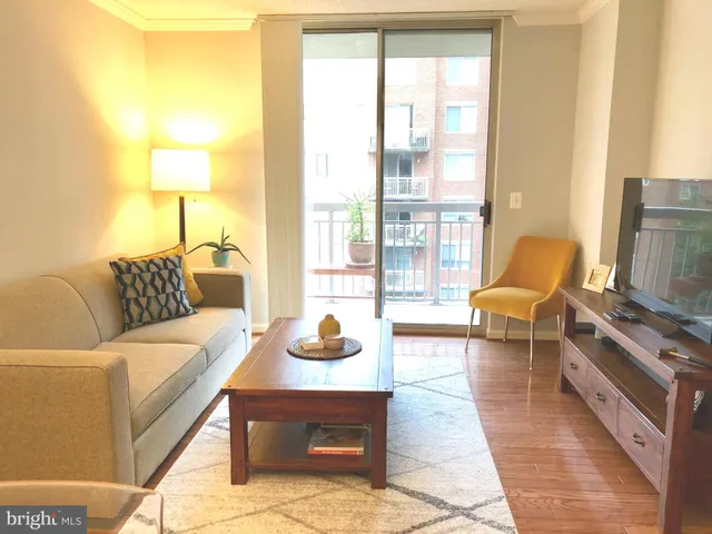 a living room with furniture and a lamp