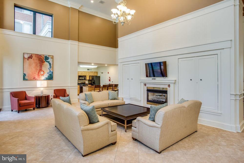3830 9th Street North, Unit 607E Arlington, VA 22203 - Photo 12 of 17 a living room with furniture a fireplace and a chandelier
