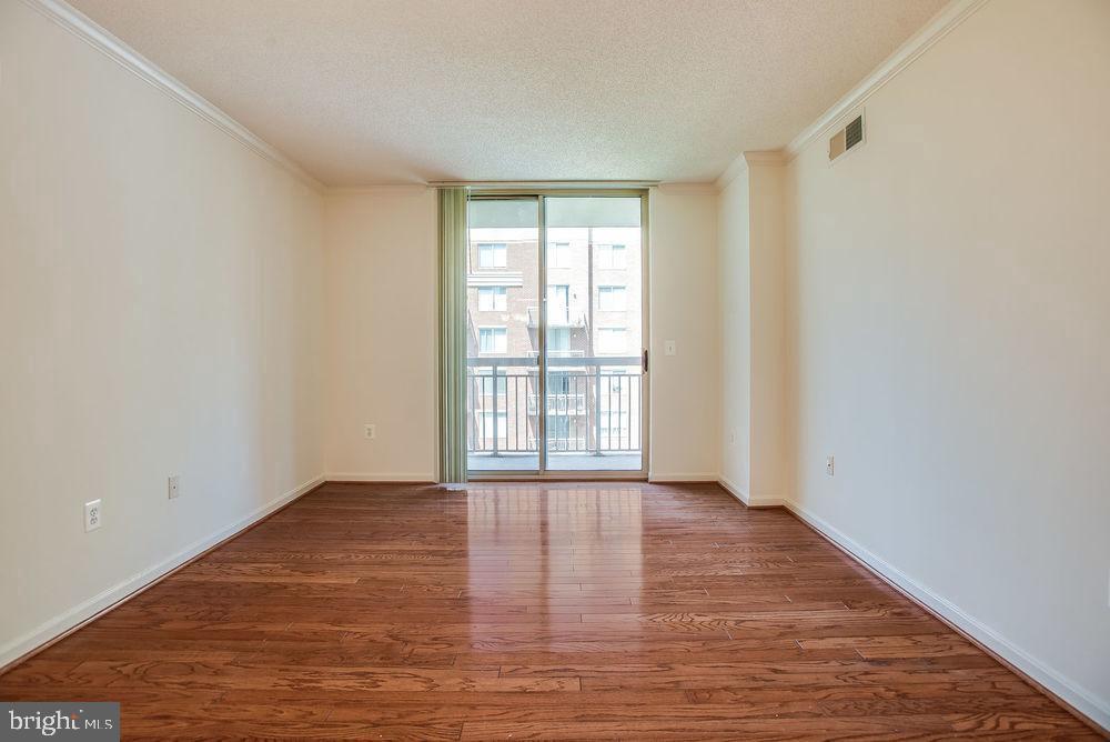 3830 9th Street North, Unit 607E Arlington, VA 22203 - Photo 2 of 17 a view of an empty room with wooden floor and a window