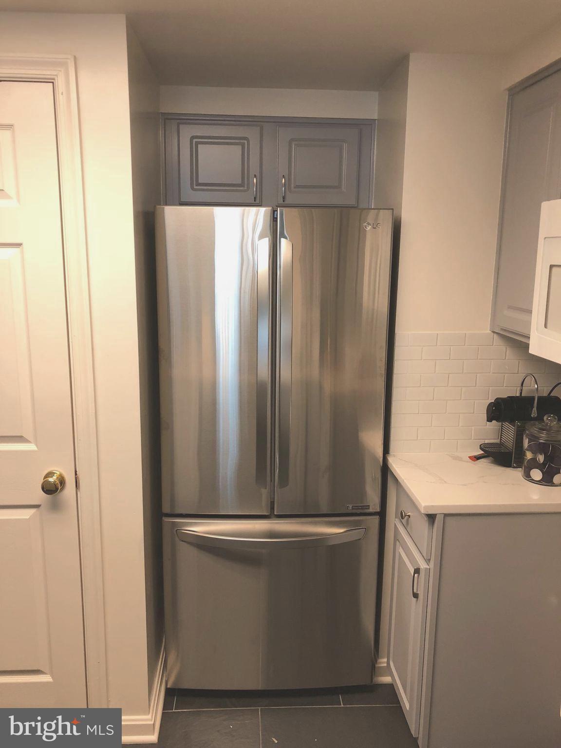 3830 9th Street North, Unit 607E Arlington, VA 22203 - Photo 5 of 17 a bathroom with a sink a washer and dryer