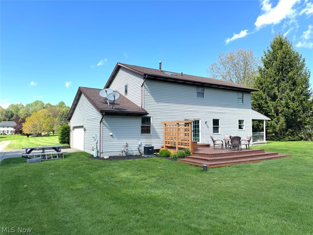3906 Webb Road Ravenna, OH 44266 - Photo 30 of 33 Expansive green lawn surrounds this property featuring light-toned siding and a multi-level wood deck