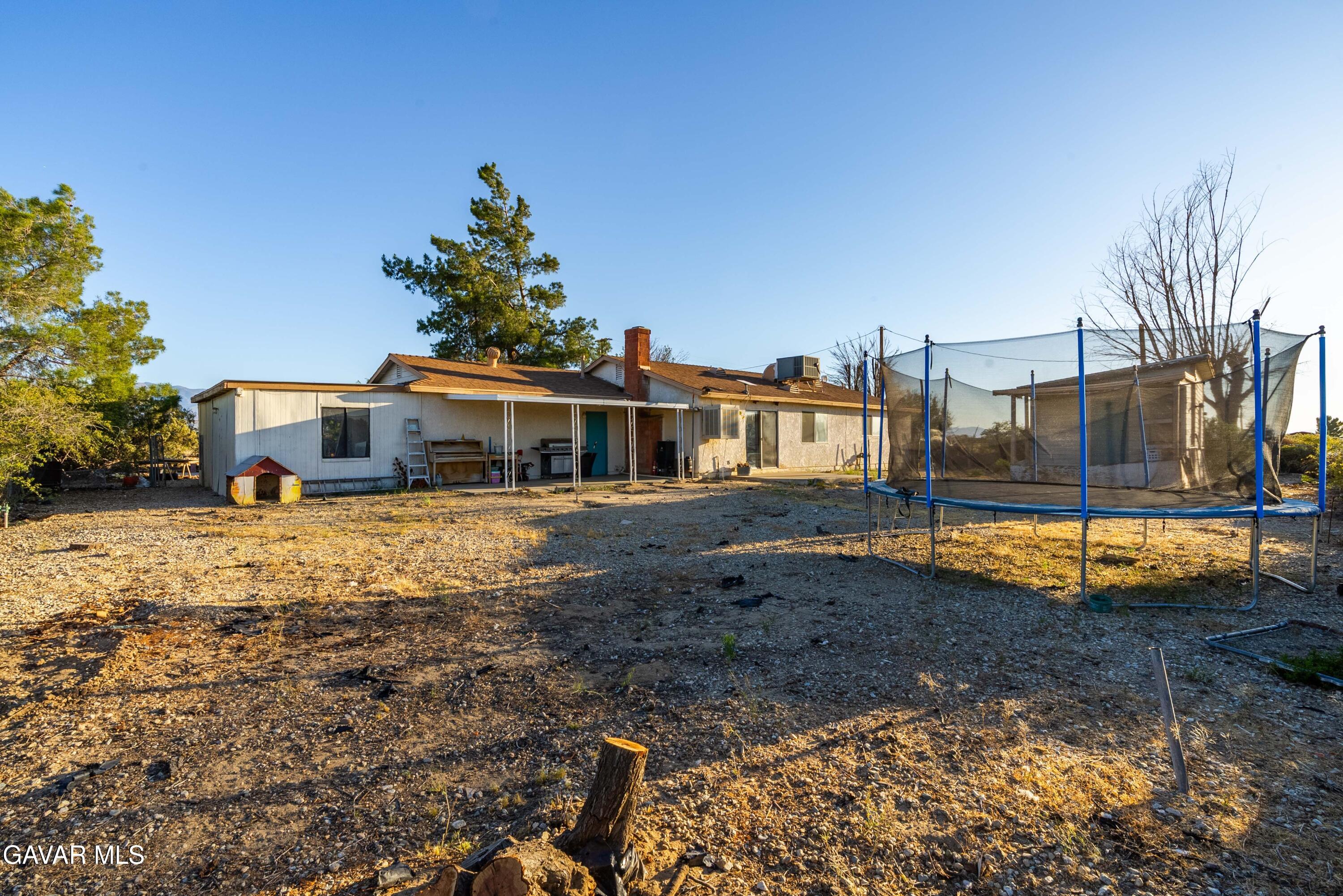 20539 East Ave R Palmdale, CA 93591 - Photo 36 of 55 a front view of a house with a yard