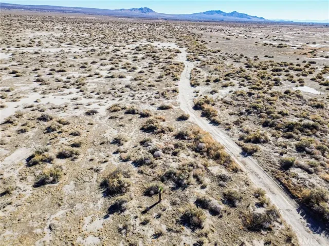 a view of an ocean beach and mountain