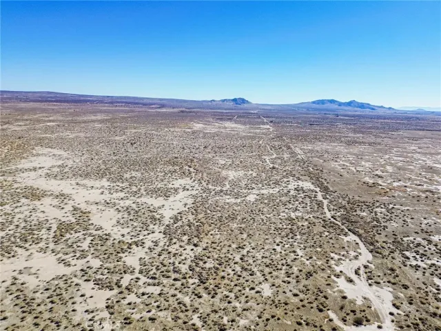 a view of a large mountain with a mountain in the background