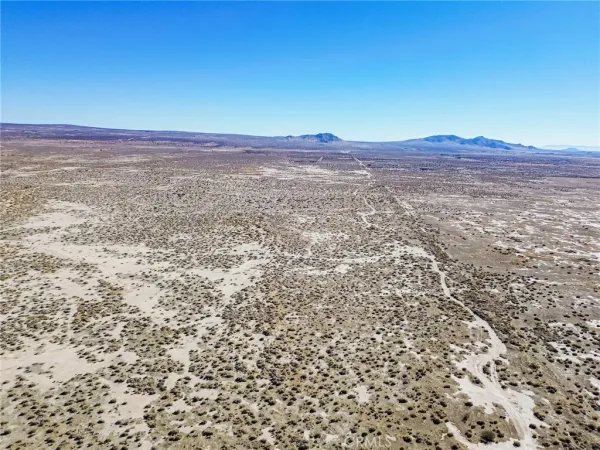 a view of a large mountain with a mountain in the background