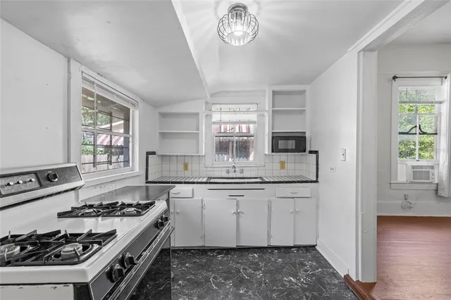a bathroom with a sink toilet and a mirror