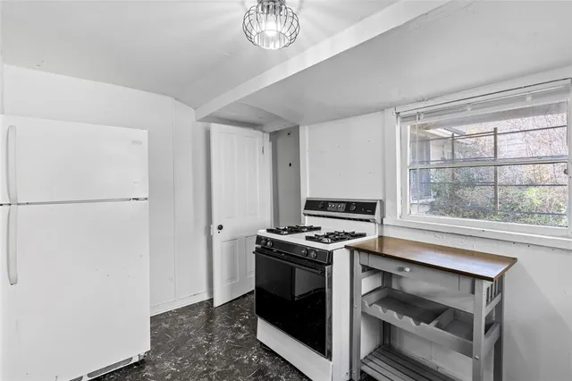 a bathroom with a sink toilet and a window