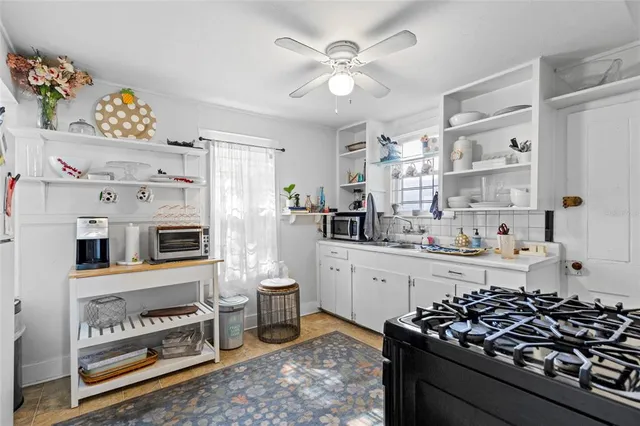 a view of a house with a large window and wooden fence