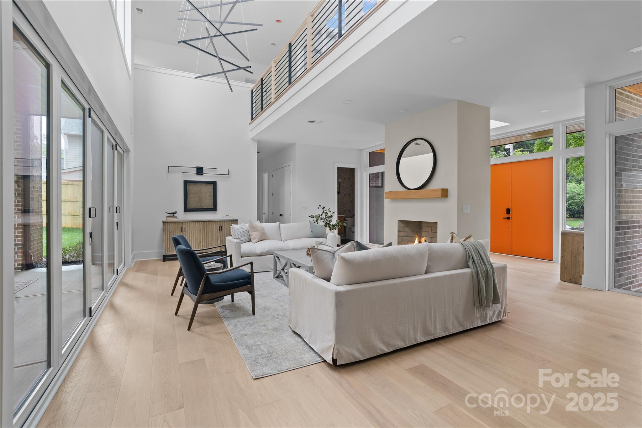 3822 Topsfield Road Charlotte, NC 28211 - Photo 15 of 43 a living room with furniture a fireplace and a chandelier