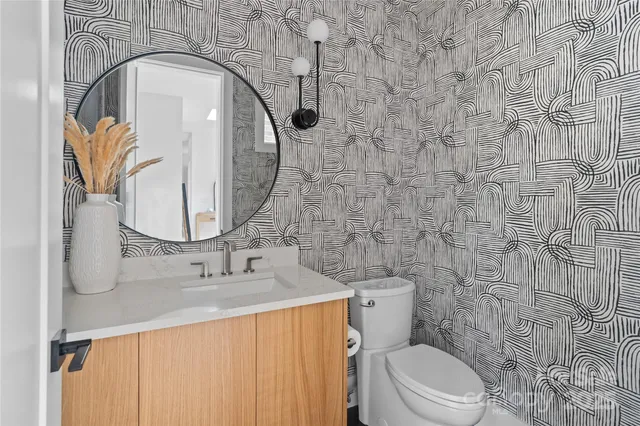 a bathroom with a sink a toilet and a mirror