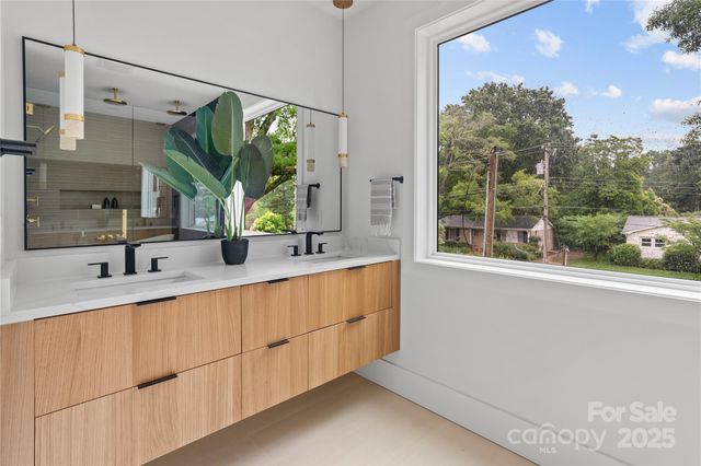 a bathroom with a double vanity sink and mirror