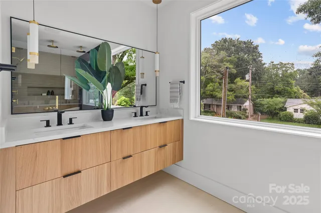 a bathroom with a double vanity sink and mirror