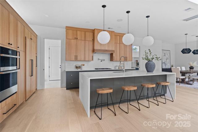 a very nice looking dining room with a large dining table and chairs