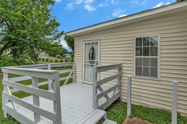 a front view of a house with a yard and trees