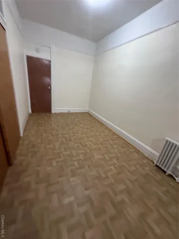 a view of a kitchen with furniture and stainless steel appliances