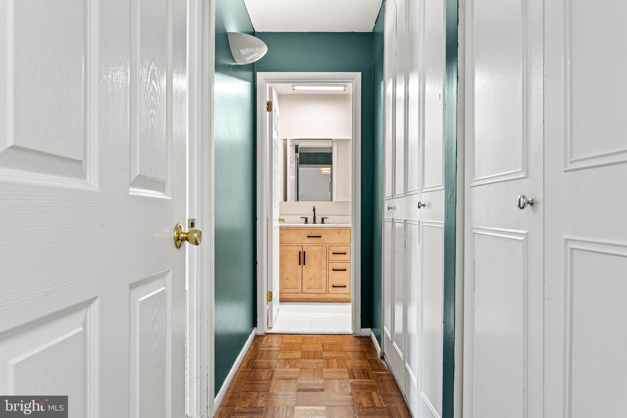 423 Old Forge Crossing, Unit 423 Devon, PA 19333 - Photo 14 of 24 Hallway w/ laundry, oversized closet, bathroom