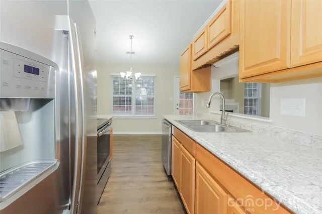 a kitchen with granite countertop a sink and cabinets
