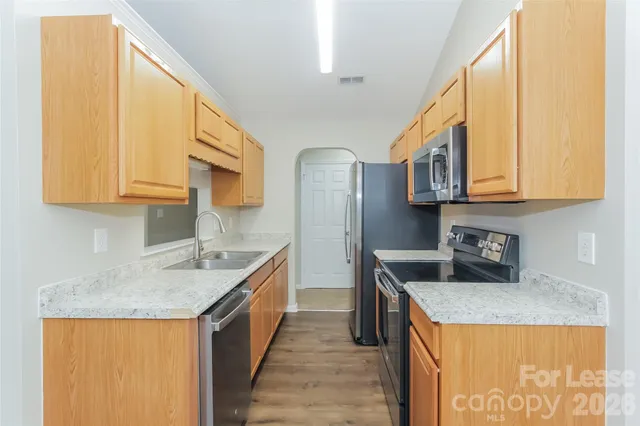 a kitchen with stainless steel appliances granite countertop a sink and cabinets