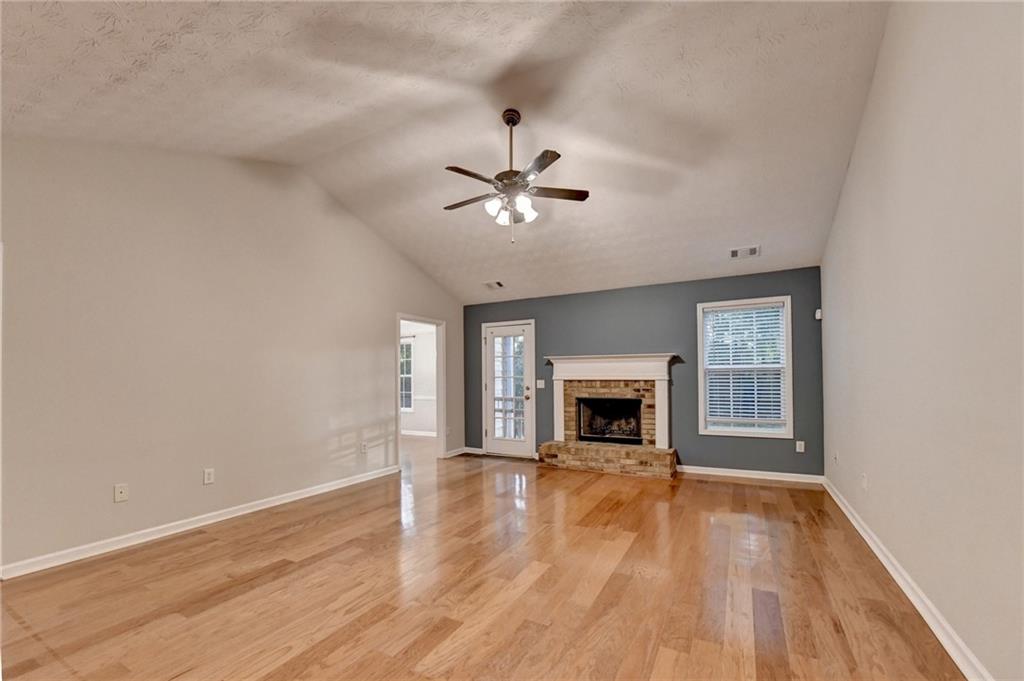 310 Andrew Ridge Drive Jefferson, GA 30549 - Photo 7 of 52 wooden floor fireplace and window in an empty room