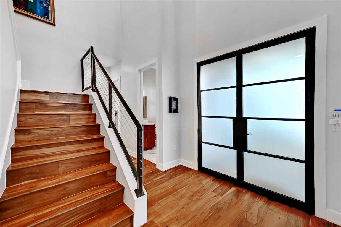 3102 Hunt Trail Austin, TX 78757 - Photo 21 of 38 Foyer featuring stairway, light wood-type flooring, and a high ceiling