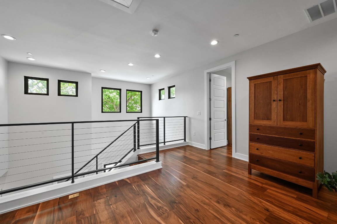3102 Hunt Trail Austin, TX 78757 - Photo 22 of 38 Spacious upstairs landing with steal railing and recessed lighting