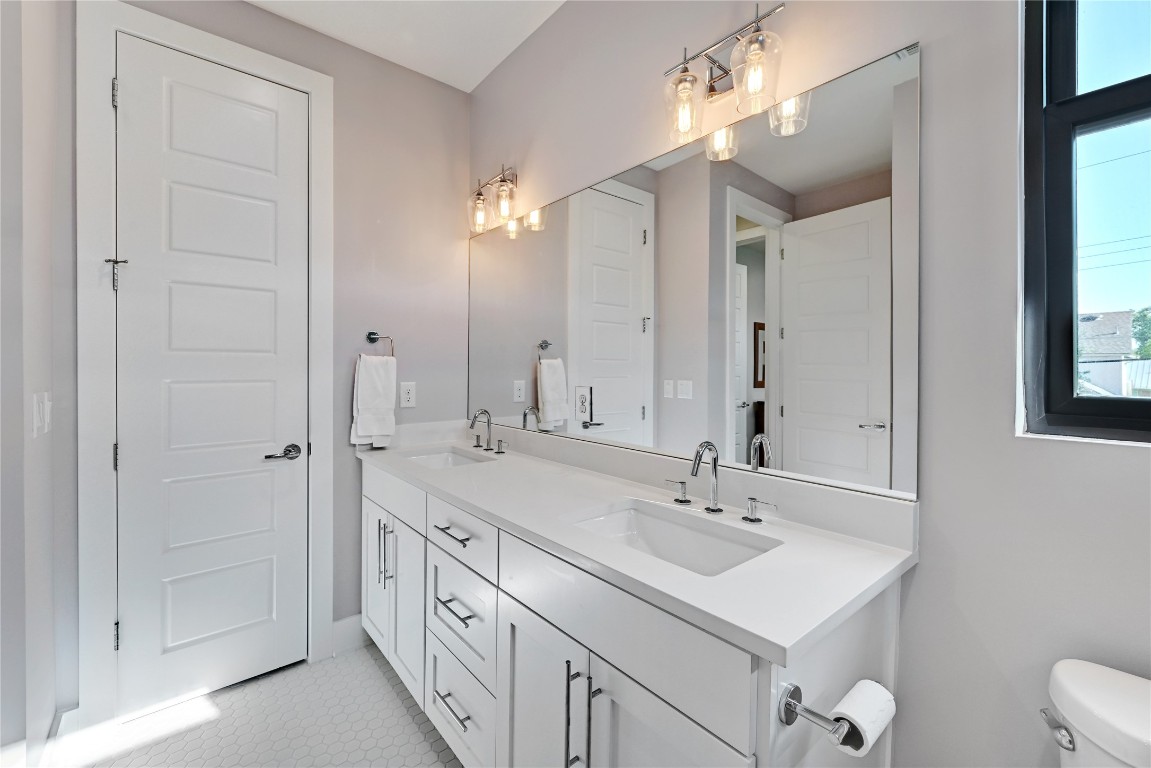3102 Hunt Trail Austin, TX 78757 - Photo 28 of 38 Bathroom with double vanity and toilet