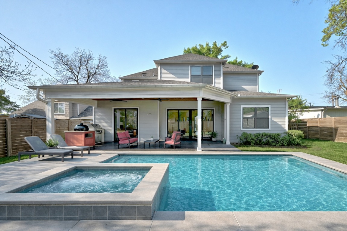 3102 Hunt Trail Austin, TX 78757 - Photo 32 of 38 Pool rendering with connected hot tub of back of property with a patio, a fenced backyard, and a ceiling fan.