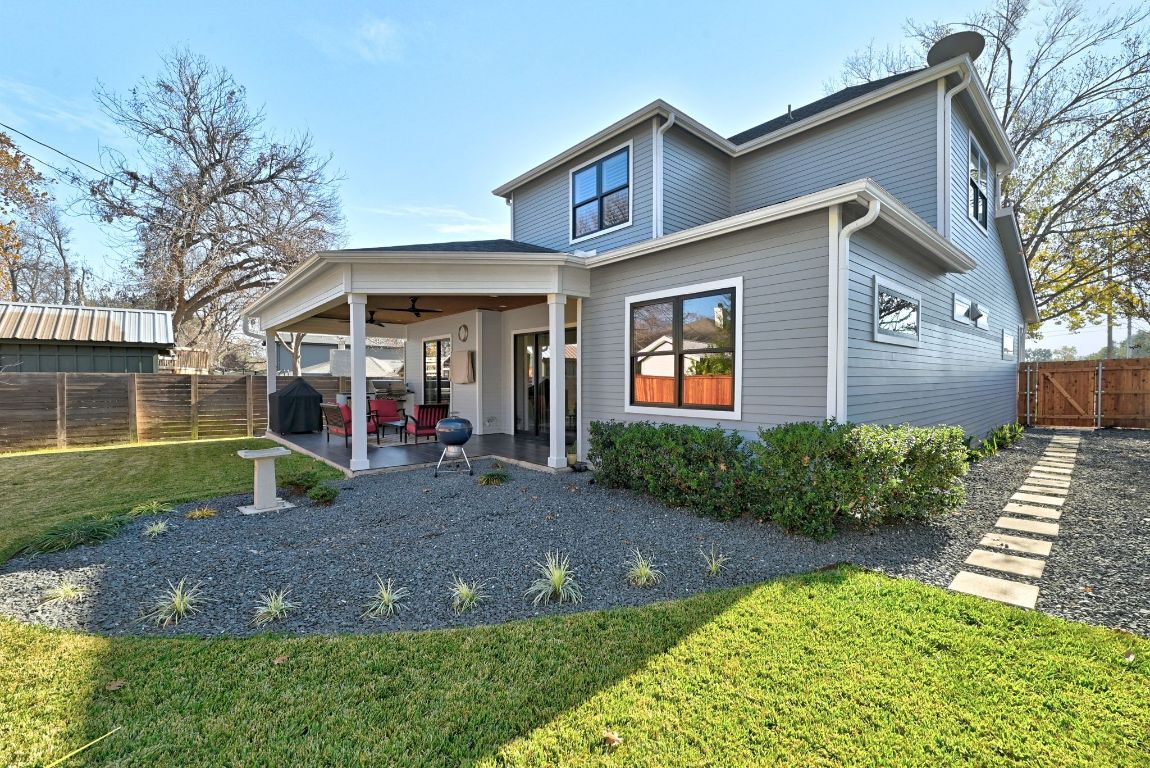 3102 Hunt Trail Austin, TX 78757 - Photo 35 of 38 Back of house featuring a fenced backyard, a patio area, a ceiling fan, and a gate