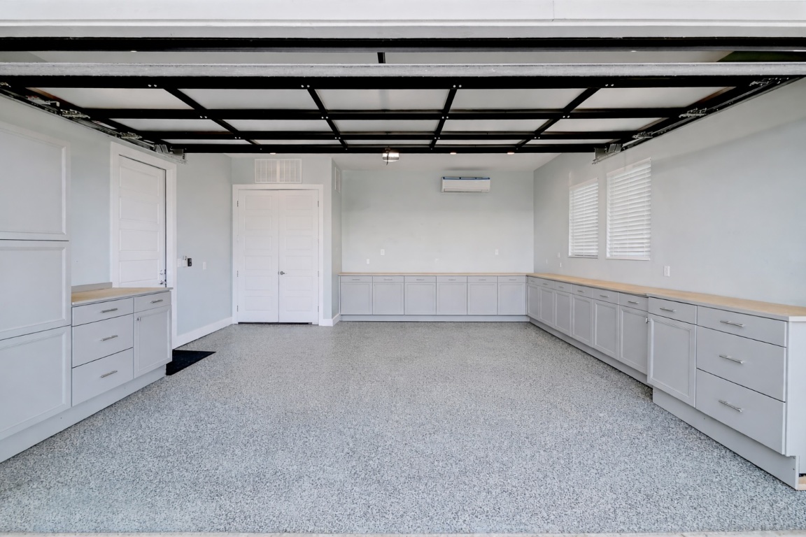 3102 Hunt Trail Austin, TX 78757 - Photo 37 of 38 Garage with ample storage baseboards and resin flooring.