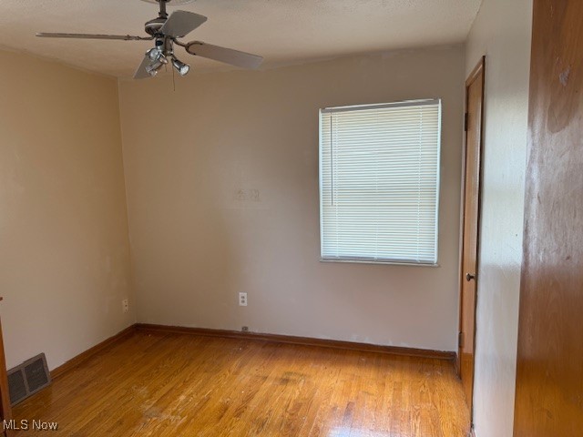 15513 Rockside Road Maple Heights, OH 44137 - Photo 4 of 11 Spare room featuring light wood-type flooring, ceiling fan, and a textured ceiling