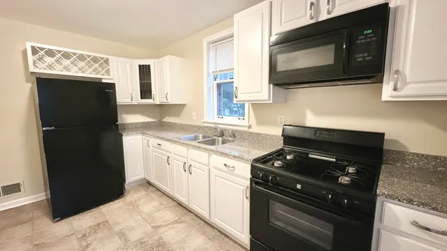 a kitchen with a refrigerator stove and microwave