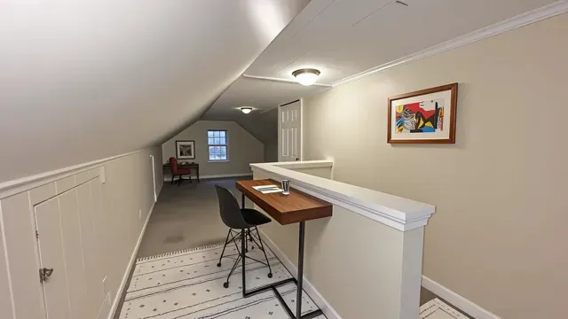 a view of a room with furniture and wooden floor