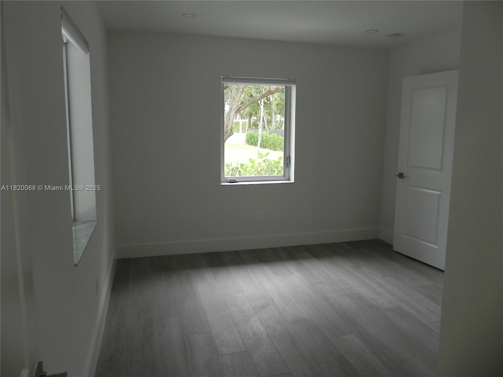 Bayside Miami, FL 33138 - Photo 18 of 44 an empty room with wooden floor and windows