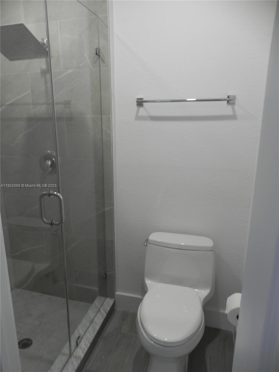 Bayside Miami, FL 33138 - Photo 19 of 44 a white toilet sitting next to a shower
