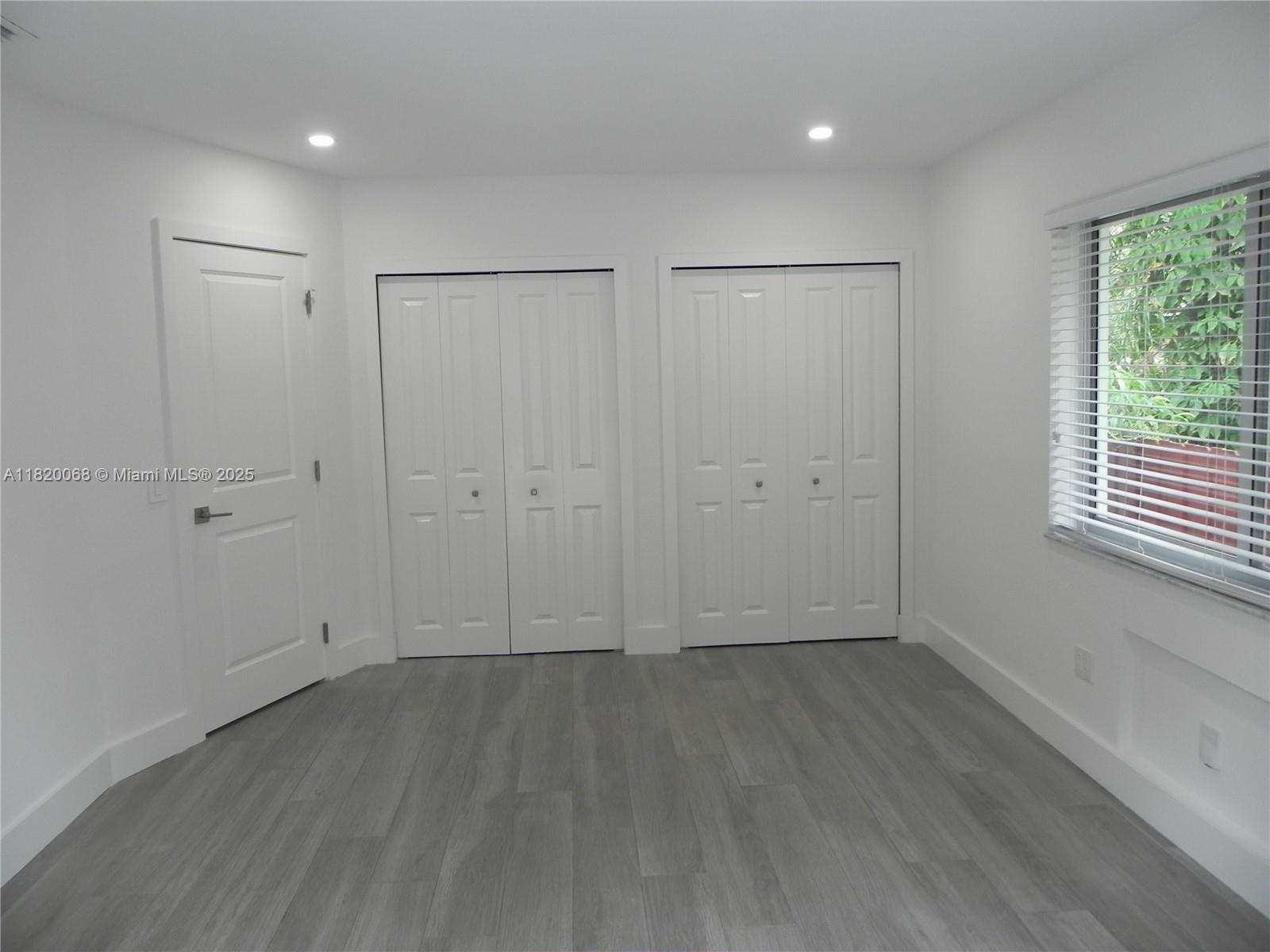Bayside Miami, FL 33138 - Photo 21 of 44 an empty room with wooden floor and windows