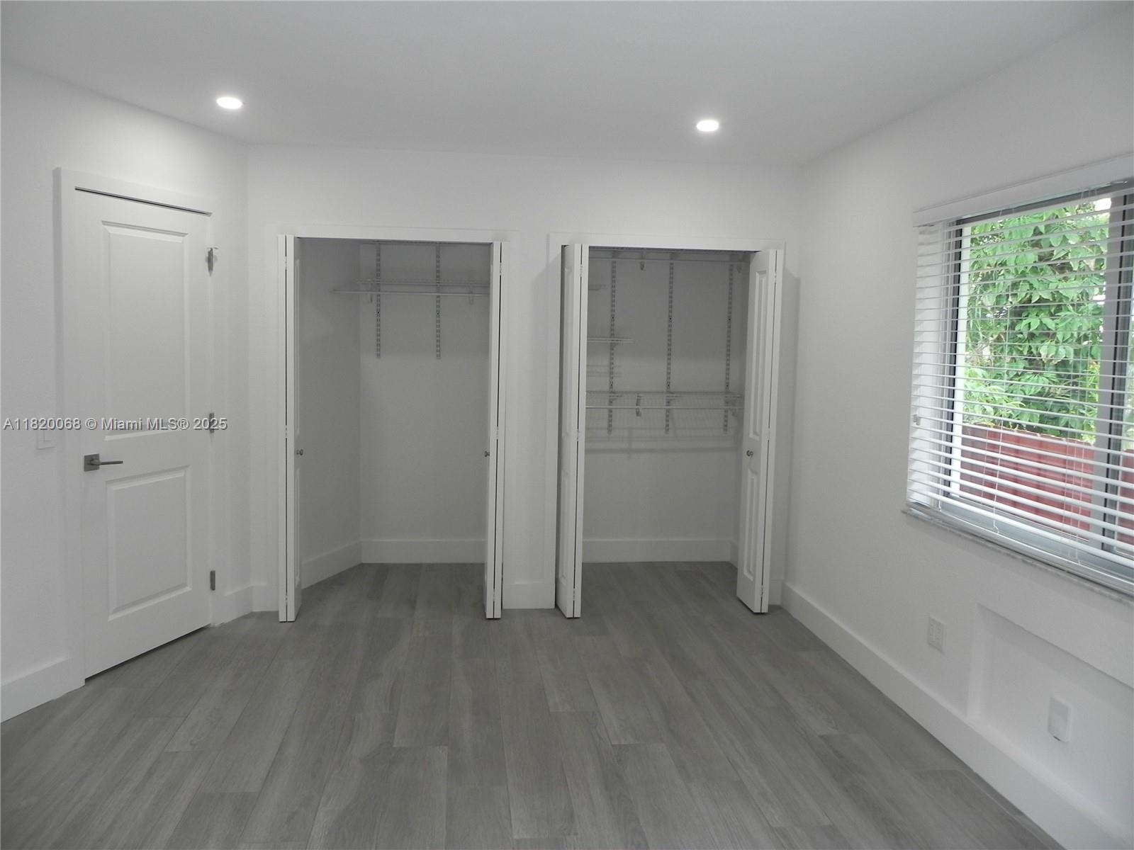 Bayside Miami, FL 33138 - Photo 22 of 44 a view of an empty room with wooden floor and a window