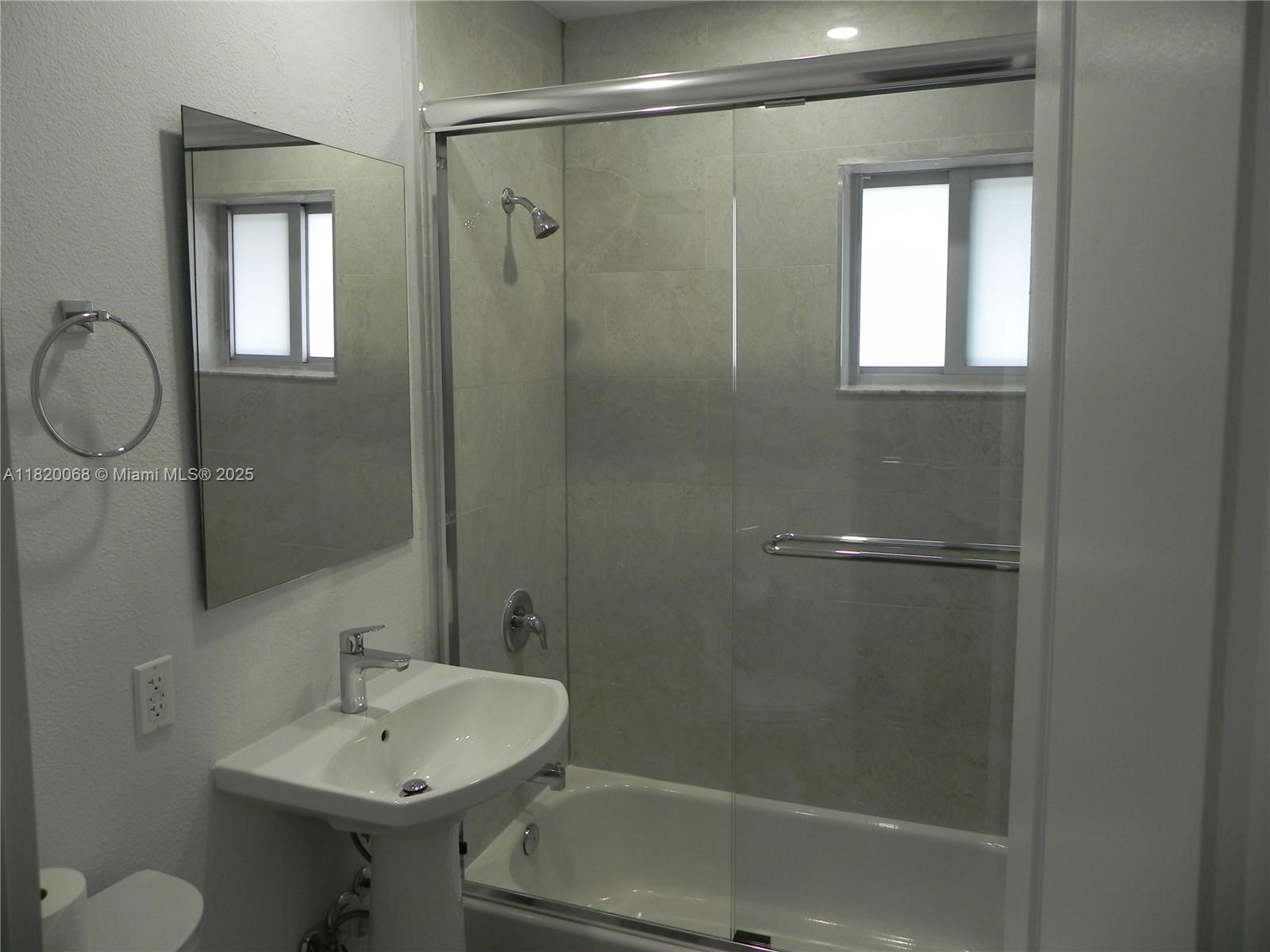 Bayside Miami, FL 33138 - Photo 23 of 44 a bathroom with a sink shower and a mirror