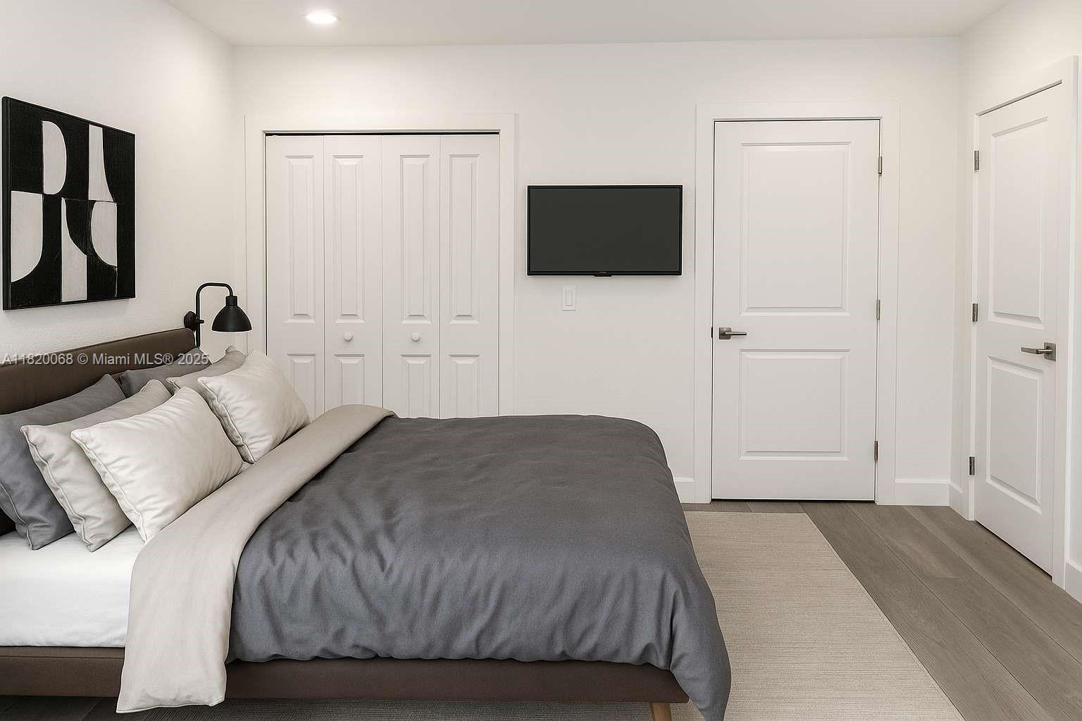 Bayside Miami, FL 33138 - Photo 25 of 44 a bedroom with a bed and a flat screen tv