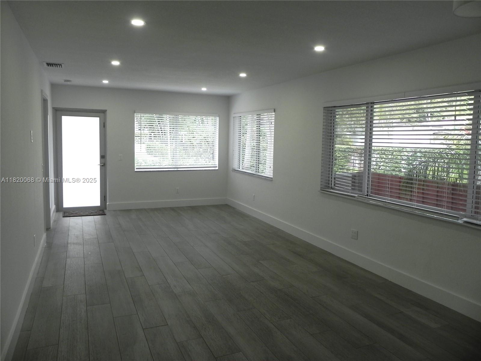 Bayside Miami, FL 33138 - Photo 7 of 44 an empty room with wooden floor and windows