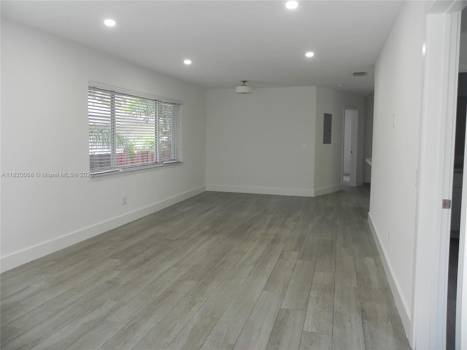 Bayside Miami, FL 33138 - Photo 9 of 44 an empty room with wooden floor and windows