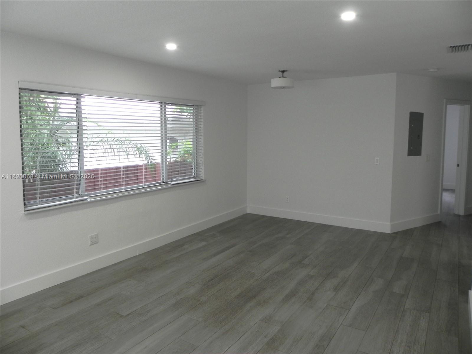 Bayside Miami, FL 33138 - Photo 10 of 44 an empty room with wooden floor and windows