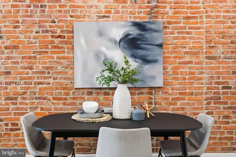 a dining room with furniture and a mirror