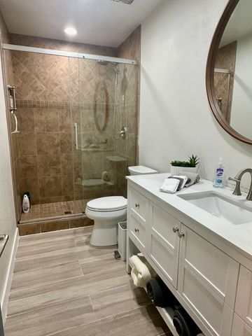 a bathroom with a double vanity sink toilet and a mirror