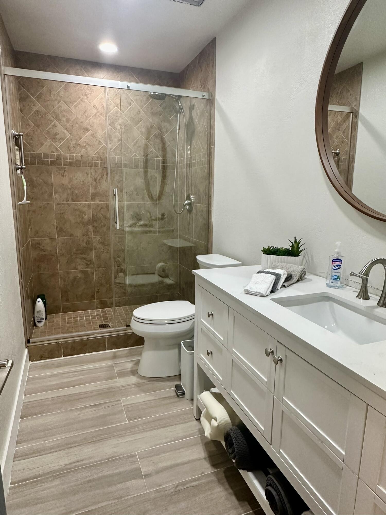 246 Santa Barbara Circle Palm Desert, CA 92260 - Photo 14 of 16 a bathroom with a double vanity sink toilet and a mirror