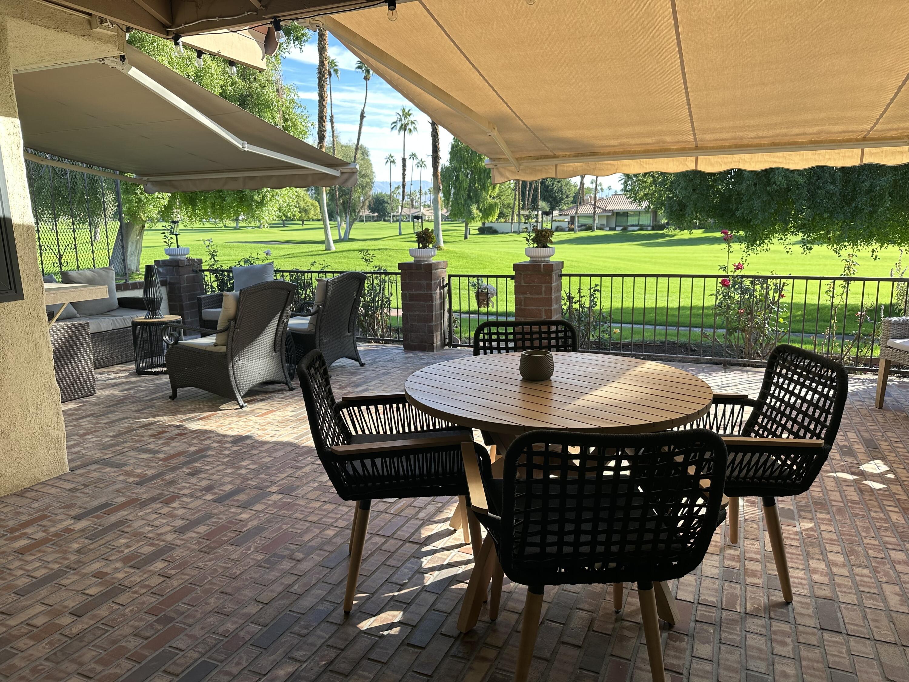 246 Santa Barbara Circle Palm Desert, CA 92260 - Photo 3 of 16 a view of a patio with a table chairs and a backyard